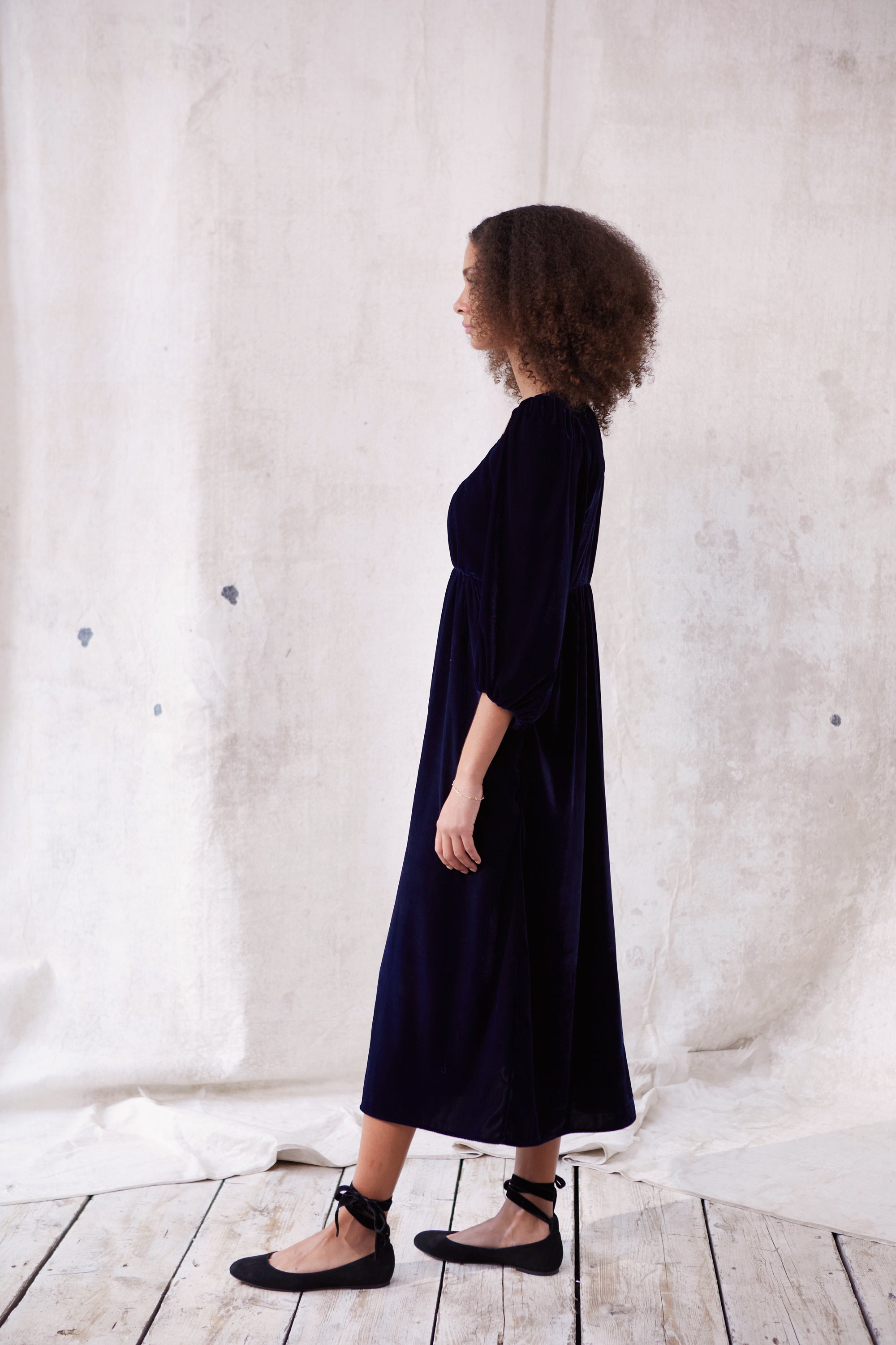 Sustainable blue velvet dress. Long sleeve, low round neck, empire line. Midi length. Made in England