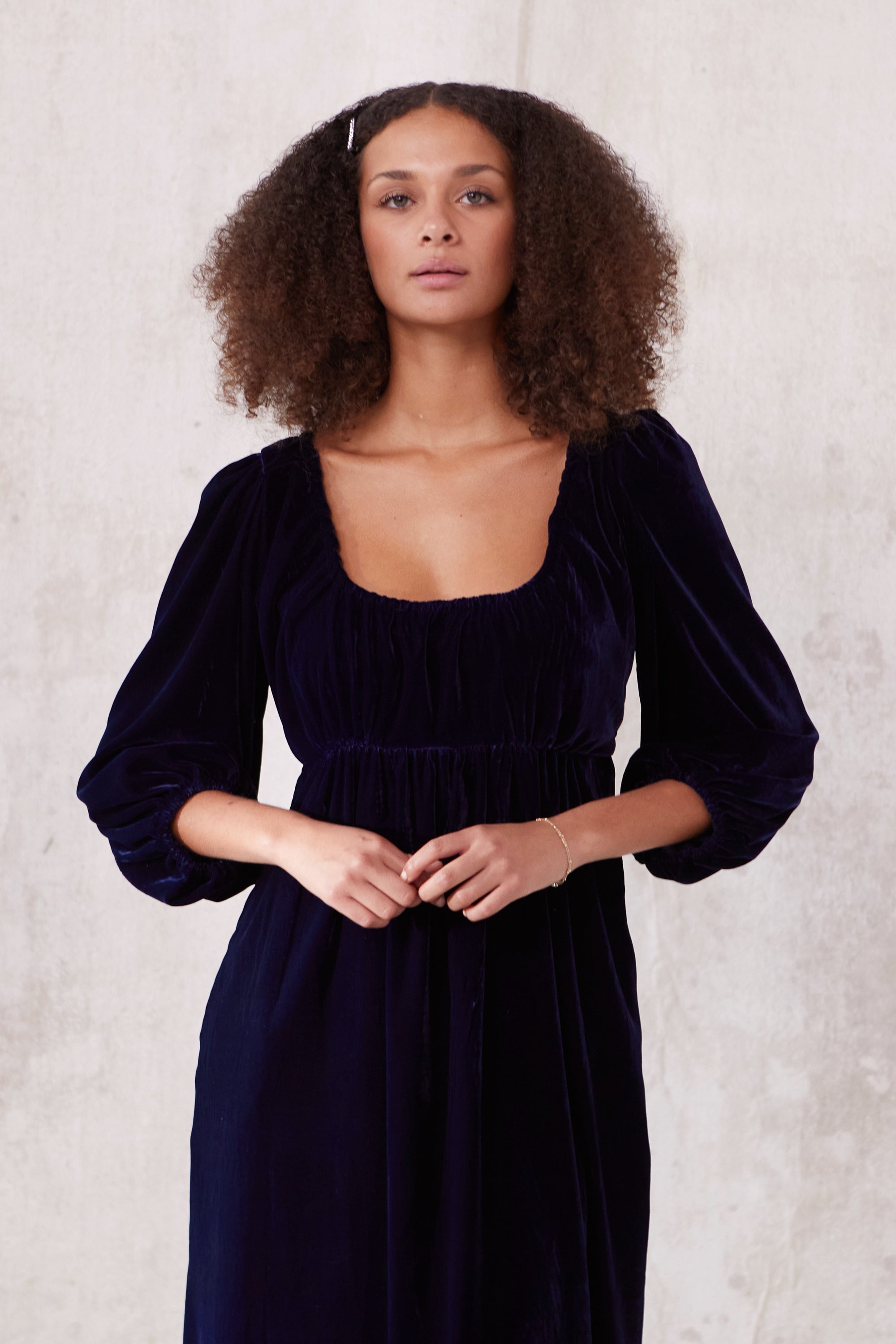 Sustainable blue velvet dress. Long sleeve, low round neck, empire line. Midi length. Made in England