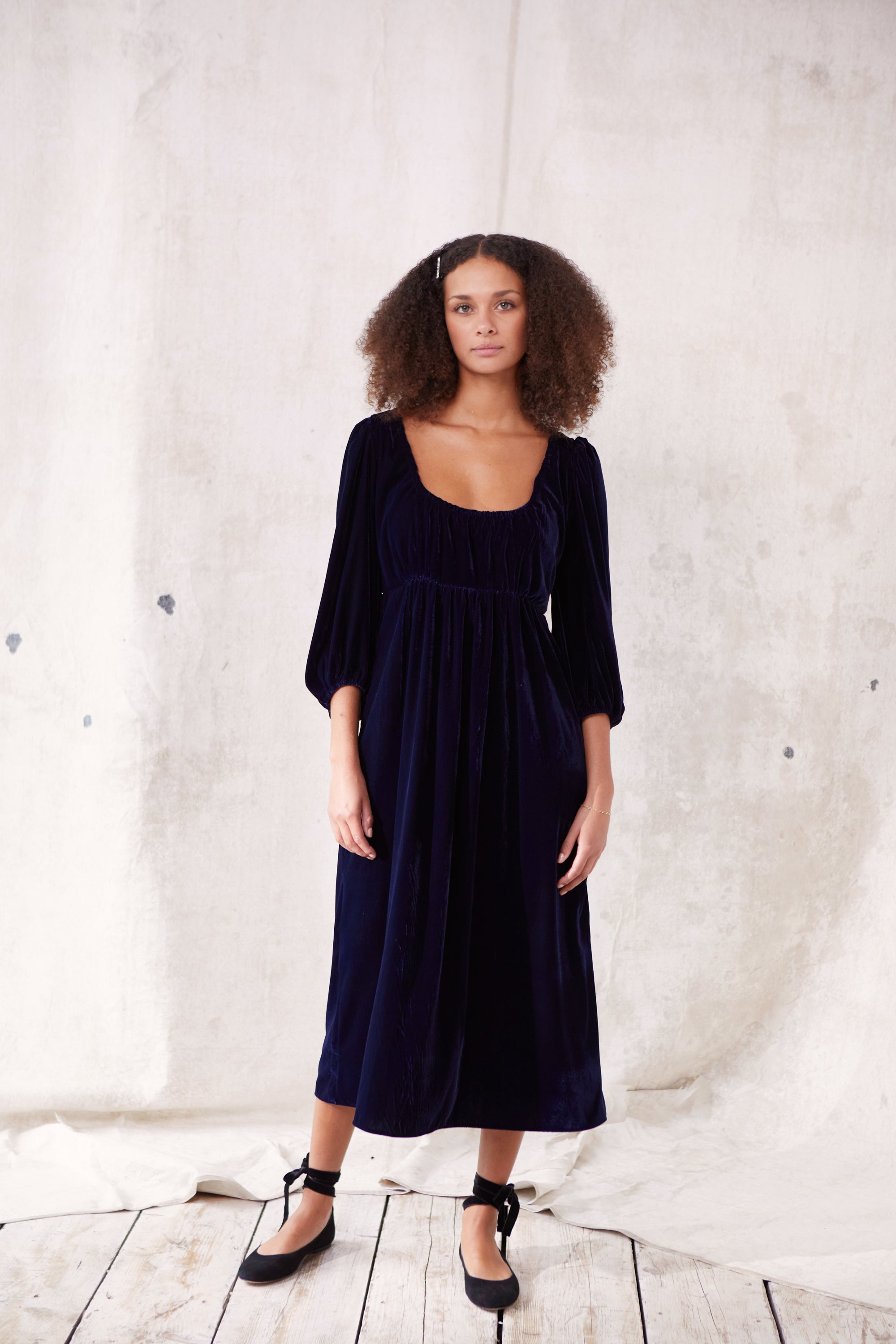 Sustainable blue velvet dress. Long sleeve, low round neck, empire line. Midi length. Made in England