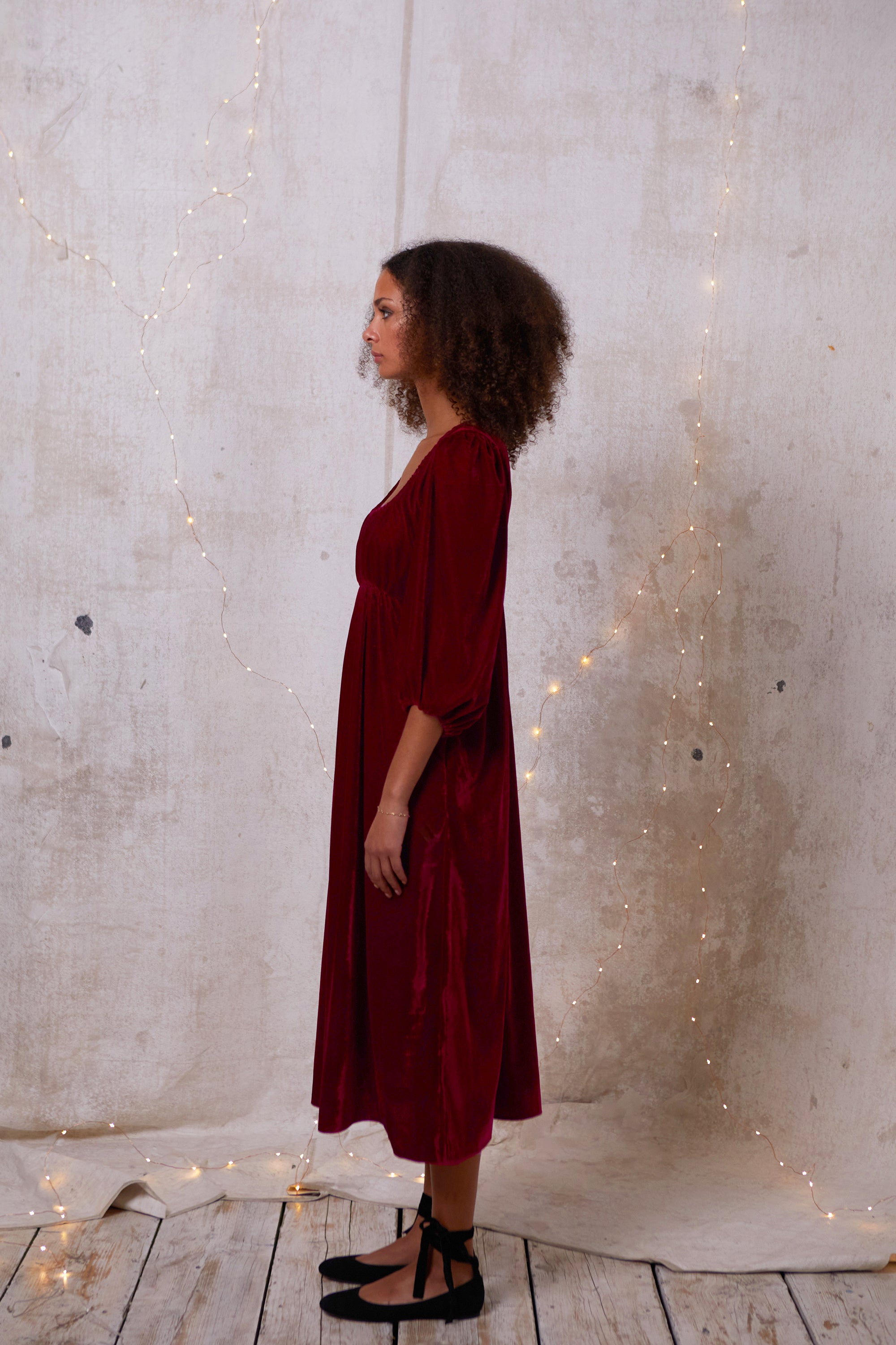 Made out of a deadstock, sustainable velvet, this dress is a 'modern romantic'. Easy and comfortable for glamorous day or party. Softly elasticated neckline, gentle gathering at the bust that sits above an empire seam giving the soft illusion of Regency dresses. Billowing sleeves gathered into a soft elastic cuff.