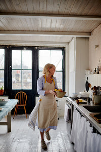 Natural linen apron with pocket and yellow straps. 