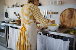 Natural linen apron with pocket and yellow straps. 