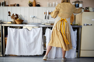 Natural linen apron with pocket and yellow straps. 