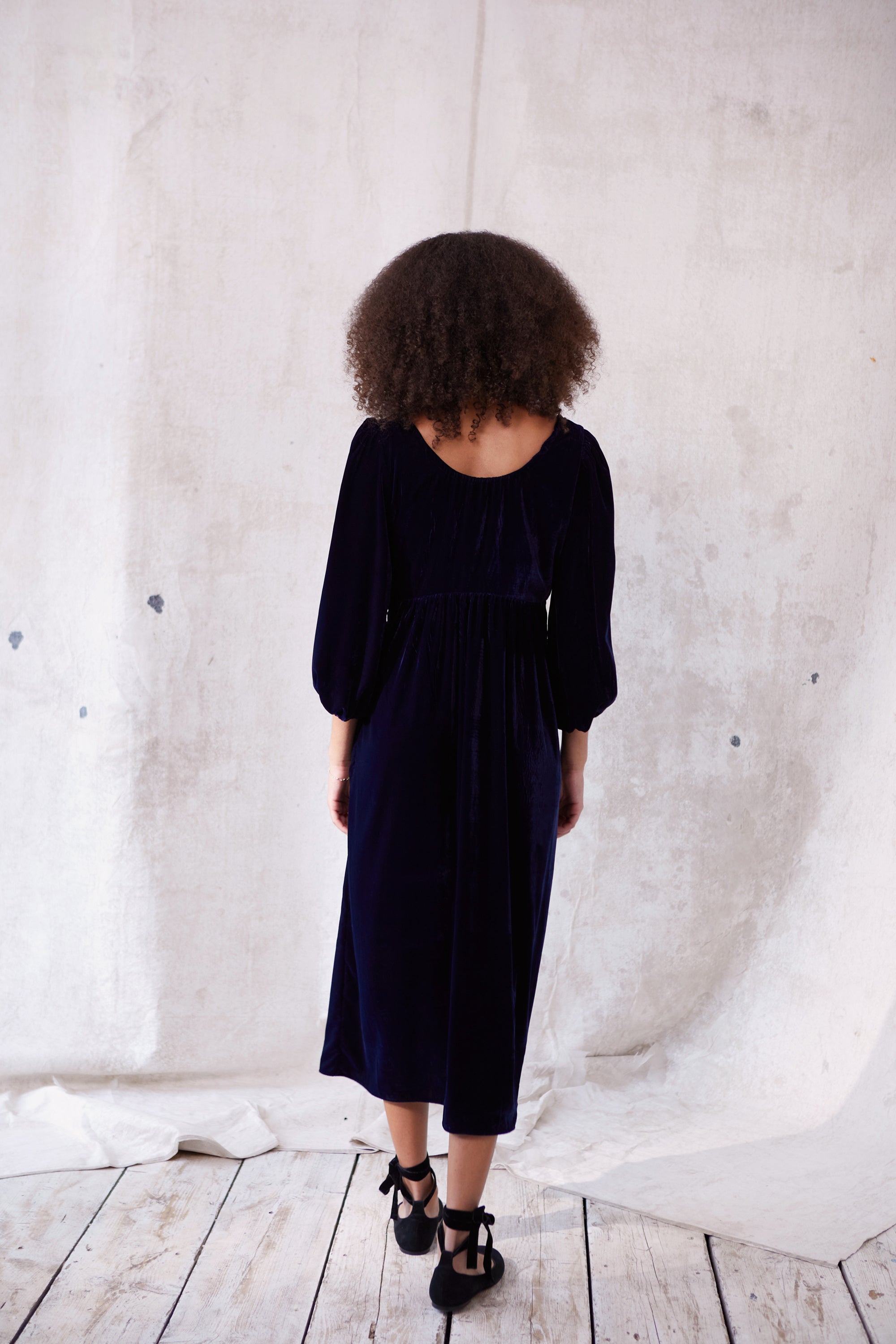 Sustainable blue velvet dress. Long sleeve, low round neck, empire line. Midi length. Made in England