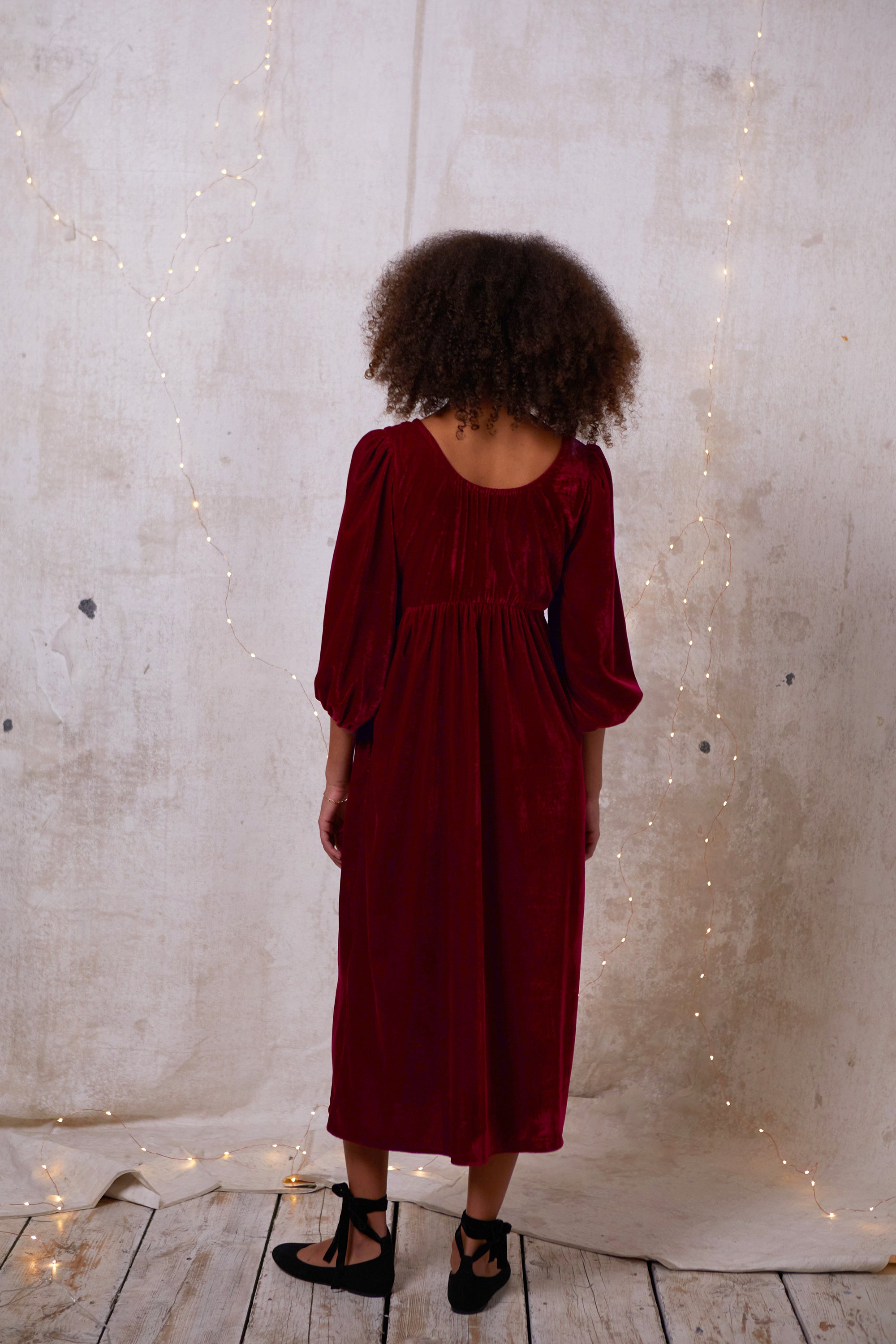 Made out of a deadstock, sustainable velvet, this dress is a 'modern romantic'. Easy and comfortable for glamorous day or party. Softly elasticated neckline, gentle gathering at the bust that sits above an empire seam giving the soft illusion of Regency dresses.  Billowing sleeves gathered into a soft elastic cuff. 